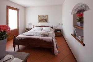 Rúm í herbergi á Agriturismo I Comelli