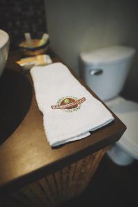 a towel on a counter next to a toilet at Bamboo Lodge Paracas in Paracas