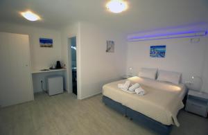 A bed or beds in a room at Amarain Mykonos