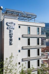 a white building with a sign on the side of it at Arka Budva in Budva