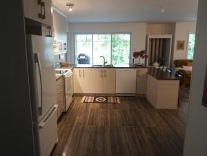 a kitchen with a refrigerator and a sink in it at Club Loisirs Nautiques Quebec in Lac-aux-Sables +35 photos