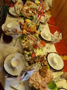 a long table with many plates of food on it at Eco Boutique Guest House Celmalas in Aglona