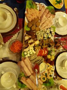 a table with a bunch of different types of food at Eco Boutique Guest House Celmalas in Aglona