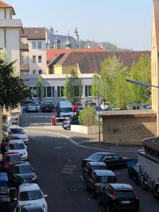 a parking lot with cars parked on the street at Apartment Central Würzburg in Würzburg