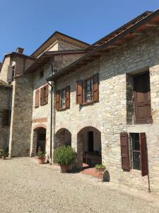 an old stone building with windows and doors at Torre Colombaia in Salsomaggiore Terme