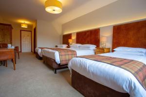 Voodi või voodid majutusasutuse Lydons Lodge Hotel toas