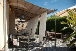 a patio with a table and chairs under awning at El Tiempo Recobrado - Hotel de silencio y relax in Villamartín de la Abadía