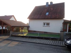 a white house with a fence and a gazebo at Kellermanns Urlaubsdomizil in Einbeck