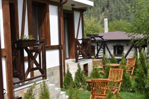 a porch with chairs and a table and a building at Bavaria House in Govedartsi
