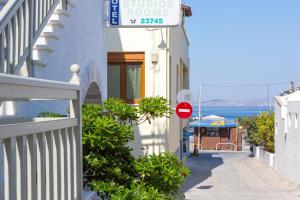 a street with a sign on the side of a building at Lygdamis Hotel in Naxos Chora
