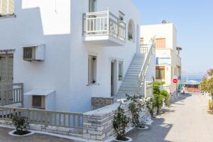 a large white building with a balcony at Lygdamis Hotel in Naxos Chora