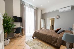 a bedroom with a bed and a desk in a room at Palazzo della Loggia B&B in Naples