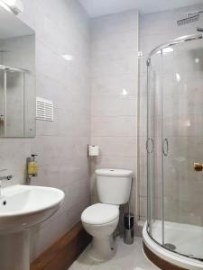 a bathroom with a toilet and a sink and a shower at Crosshill House in Glasgow