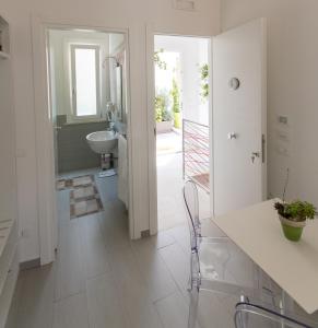 a white bathroom with a sink and a toilet at B&B MARSALA in Marsala