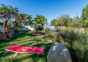 a group of surfboards laying on the grass at Boutique Hotel IBIZA in Jacó