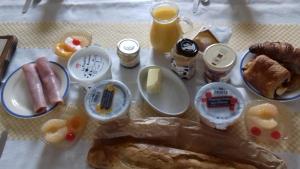 a table with a bunch of breakfast foods on it at Chambres d'Hotes Elvire et Laurent Barbey in Sainte-Marie-du-Mont