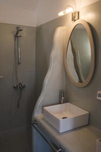 a bathroom with a sink and a mirror at Cultural House in Pirgos +22 photos