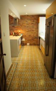 a kitchen with a tile floor with a refrigerator at Magdalena Guest House in Bogotá