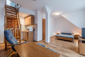 a living room with a couch and a bed at Willa Hetman in Karwia