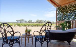 a dining room table with chairs and umbrellas at Balgownie Estate Bendigo in Bendigo