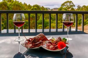 a plate of food and two glasses of wine at Rainbow Trail Chalets in Pemberton +27 photos