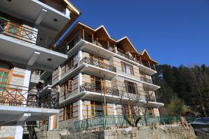 a tall building with balconies on top of it at Hotel Mountain Trail Manali in Manāli