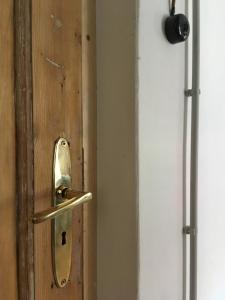 a wooden door with a door knob on it at Vintage Design Apartment in Kuldīga