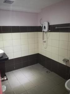 a bathroom with a shower and a sink at Micasa Hotel Labuan in Labuan