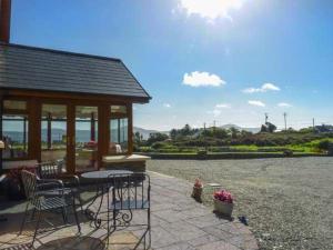 a patio with a gazebo and a table and chairs at Caola Nua in Kilcrohane