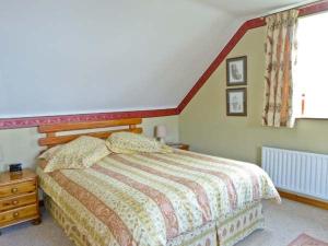 a bedroom with a bed and a dresser and a window at Carraig Oisin in Waterville