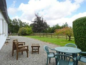 a patio with tables and chairs and a table and benches at The Range in Enniscorthy