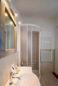 a bathroom with a sink and a mirror and a shower at Villa Cristina in Monterosso al Mare