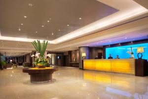 a lobby of a hotel with a reception desk and flowers at Furama Bukit Bintang, Kuala Lumpur in Kuala Lumpur