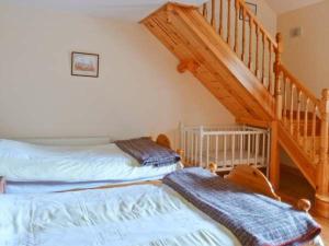 a bedroom with two twin beds and a staircase at The Range in Enniscorthy