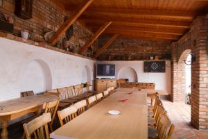 a large room with wooden tables and chairs at Janza Apartman in Bük