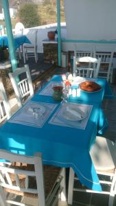 a blue table with a bowl of food on a patio at Kampos Home in Apollonia