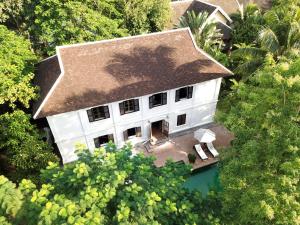 an aerial view of a white house with a roof at Satri House Hotel in Luang Prabang
