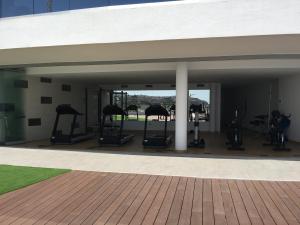 - une salle de sport avec tapis de course et vélos elliptiques dans un bâtiment dans l'établissement Infinity View, à Arenales del Sol