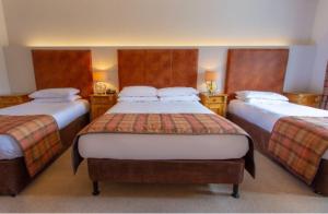 Voodi või voodid majutusasutuse Lydons Lodge Hotel toas