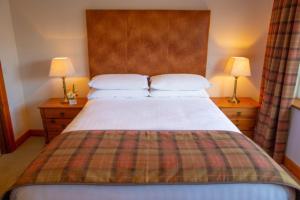 Voodi või voodid majutusasutuse Lydons Lodge Hotel toas