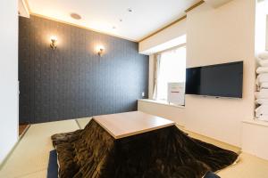 TV a/nebo společenská místnost v ubytování U-Community Hotel