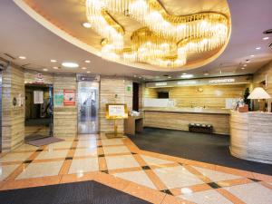 a lobby with a large chandelier in a building at Osaka Moriguchi Plaza Hotel in Osaka