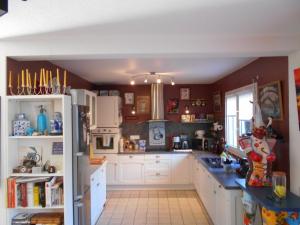 a kitchen with white cabinets and a blue counter top at maison individuelle mr Alaphilippe in Vannes