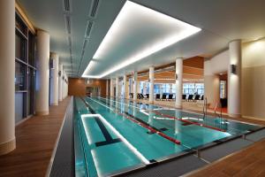 a large swimming pool in a building at Hotel Aquarius SPA in Kołobrzeg