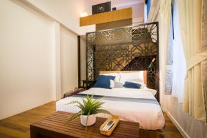 1 dormitorio con cama grande y mesa de madera en Siam Nitra Boutique Hotel, en Bangkok