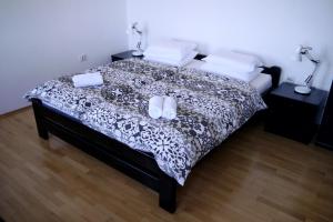 a bedroom with a bed with two slippers on it at Apartments Vrutki in Opatija