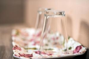 a glass jug on a plate on a table at Pensiunea Miorita Arad in Arad