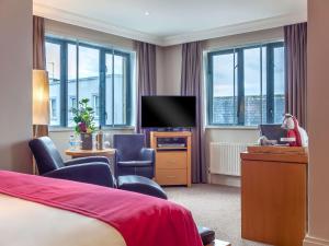 a hotel room with a bed and a flat screen tv at Prince of Wales Hotel in Athlone