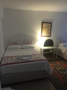 a bedroom with a bed and a table and a chair at Pasha Motel in Bodrum City