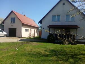 a white house with a red roof at Holiday home in Ogre